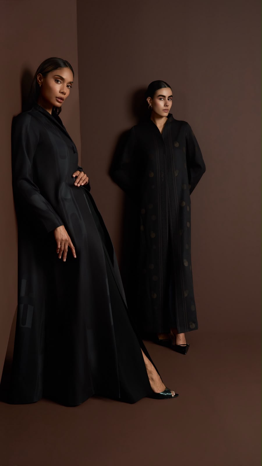 HAYA campaign — two models in charcoal abayas